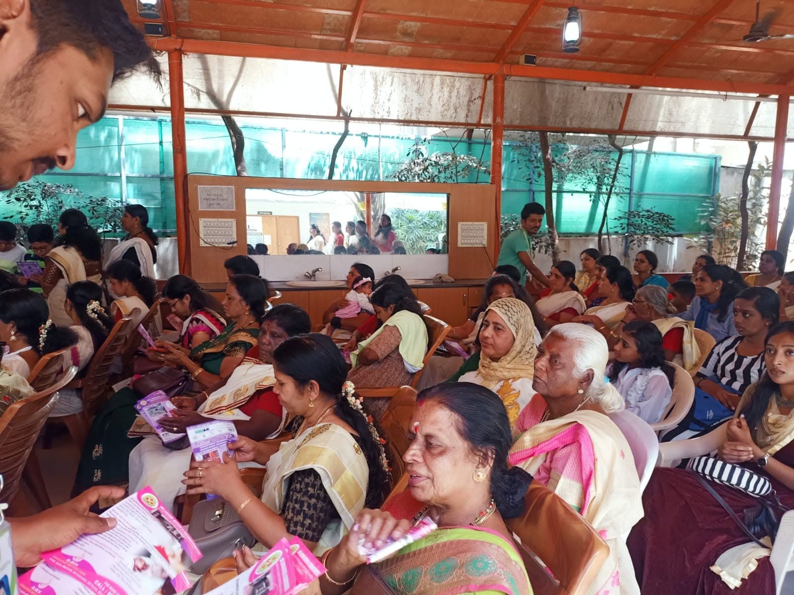 A large seated audience, mostly women, at a Sri Lakshmi Healthcare community health awareness session.